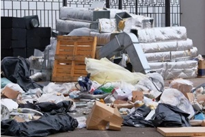 construction garbage, cardboard, polyethylene after building repair. Removal of Baltimore city debris. Bunch of trash